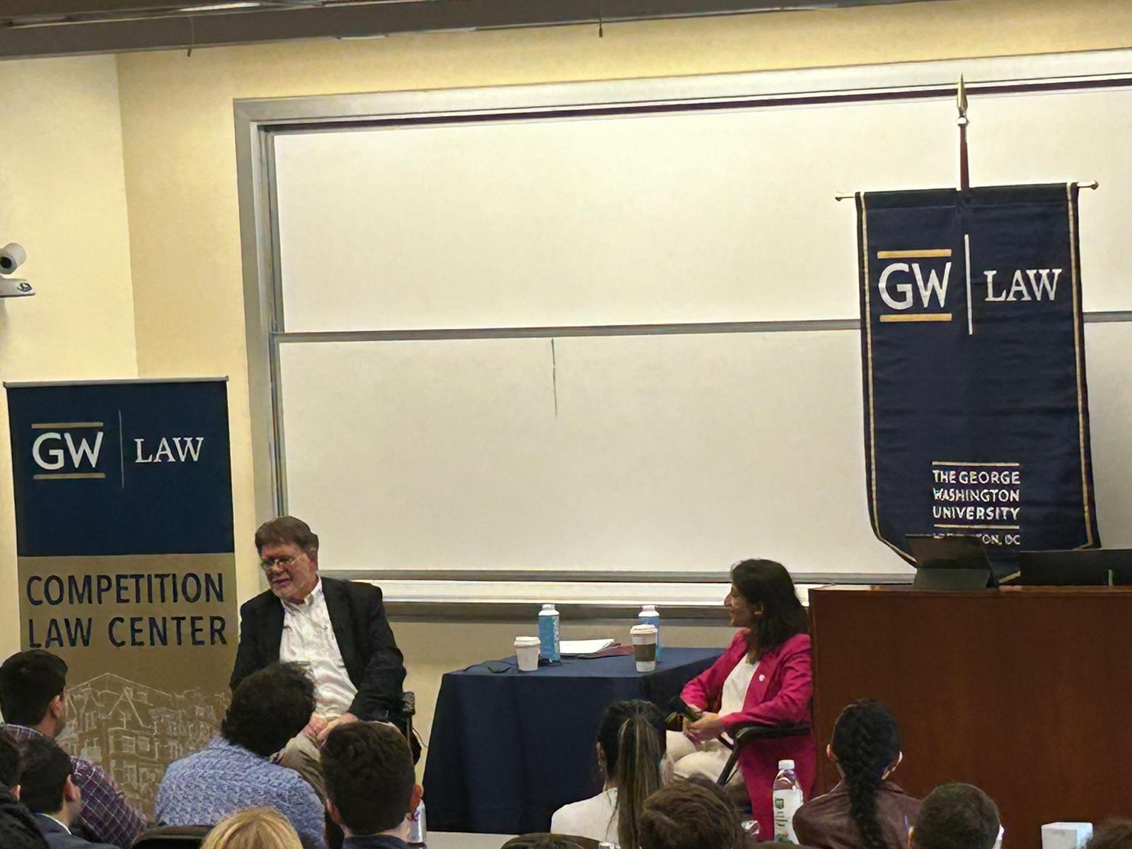 Bill Kovacic and Lina Khan speaking in front of a classroom of people